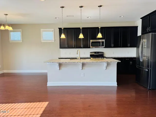 a kitchen with a sink and a refrigerator