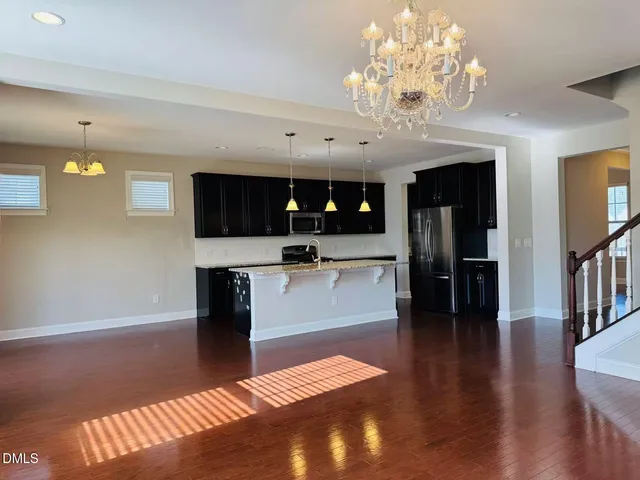 a living room with stainless steel appliances kitchen island granite countertop furniture and a kitchen view