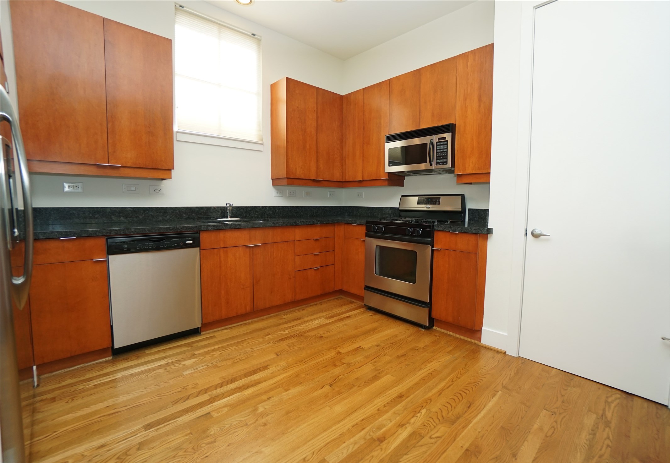 4313 Feagan Street, Unit A Houston, TX 77007 - Photo 5 of 20 a kitchen with stainless steel appliances granite countertop a stove a sink and a microwave
