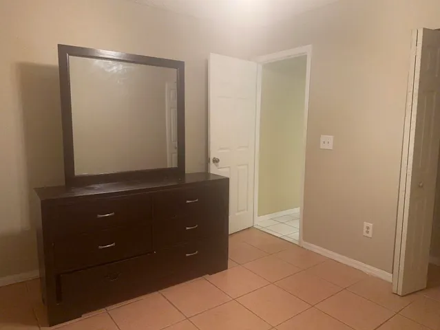 a room with a mirror and a cabinet