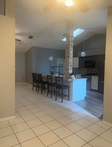 a kitchen with stainless steel appliances kitchen island granite countertop a sink cabinets and microwave