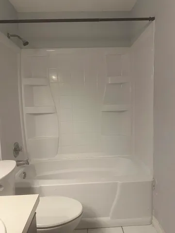 a bathroom with a bathtub and a toilet