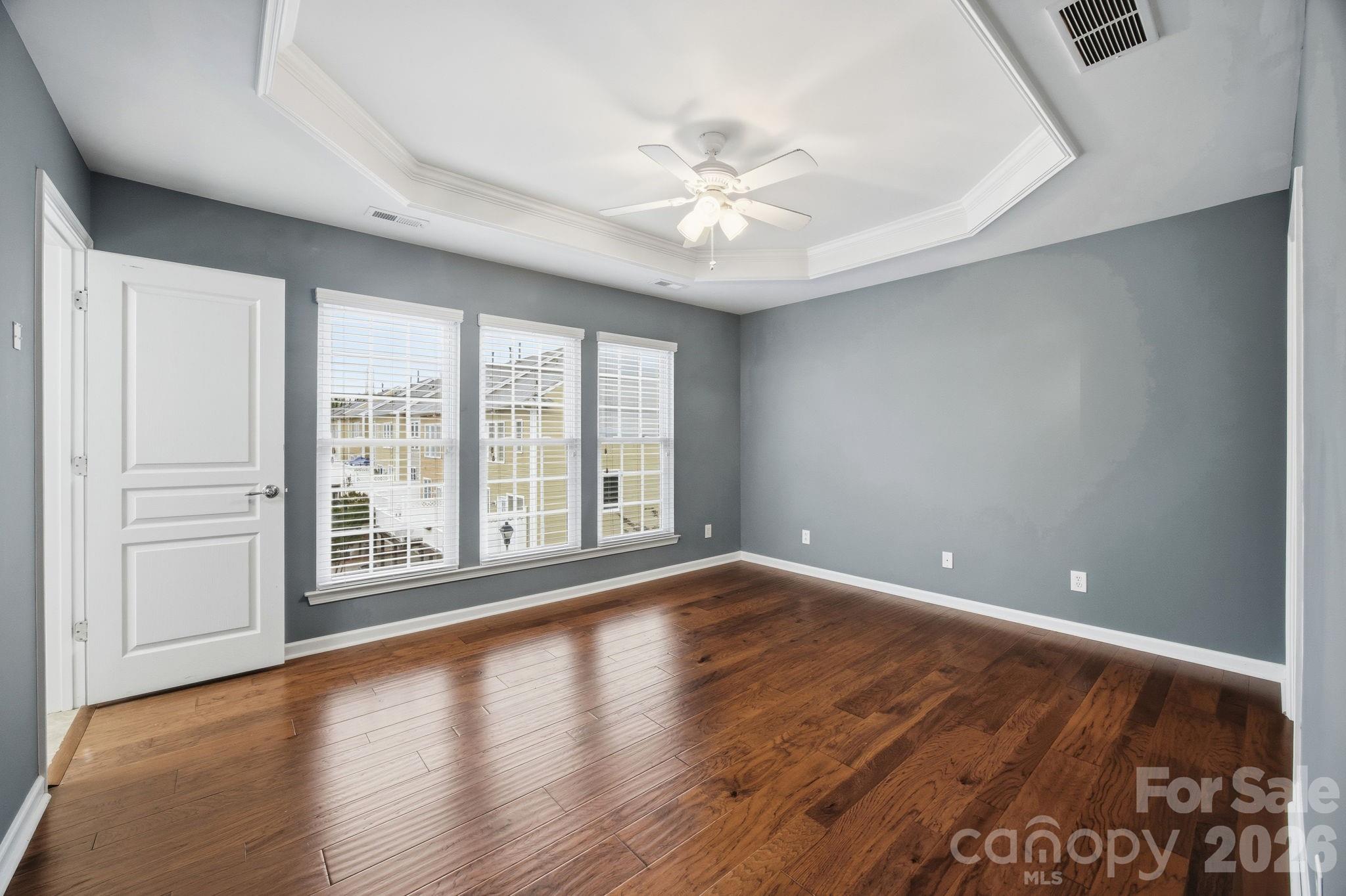 645 6th Baxter Crossing Fort Mill, SC 29708 - Photo 13 of 32 a view of an empty room with wooden floor and a window