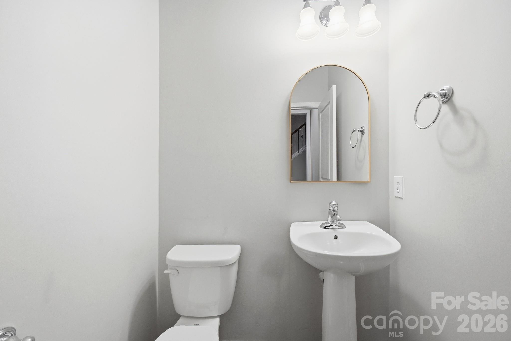 645 6th Baxter Crossing Fort Mill, SC 29708 - Photo 18 of 32 a bathroom with a toilet sink and mirror