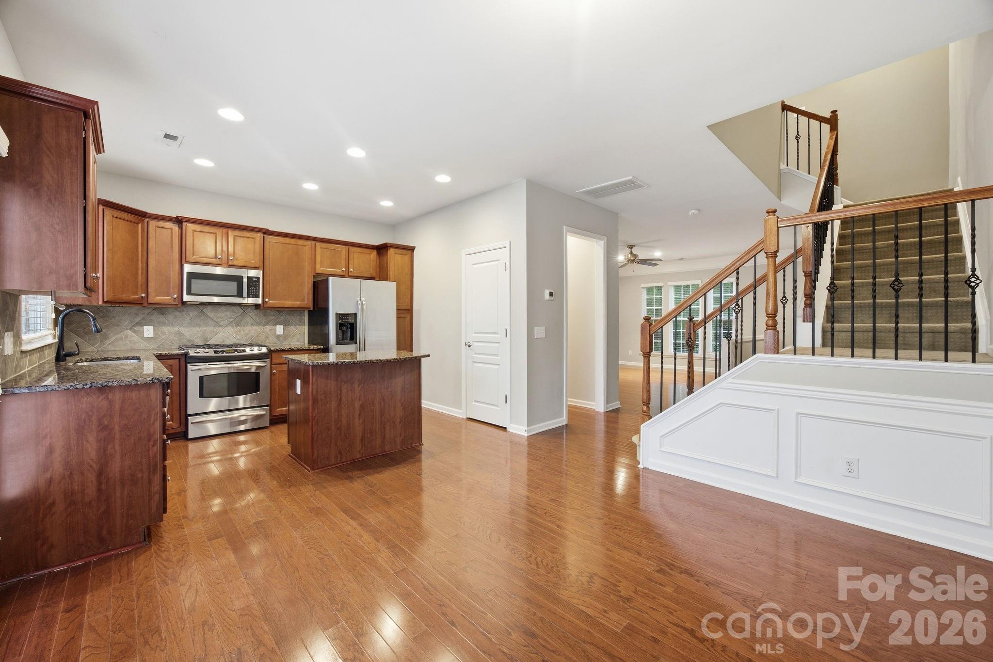 645 6th Baxter Crossing Fort Mill, SC 29708 - Photo 2 of 32 a kitchen with stainless steel appliances granite countertop a refrigerator and a stove top oven