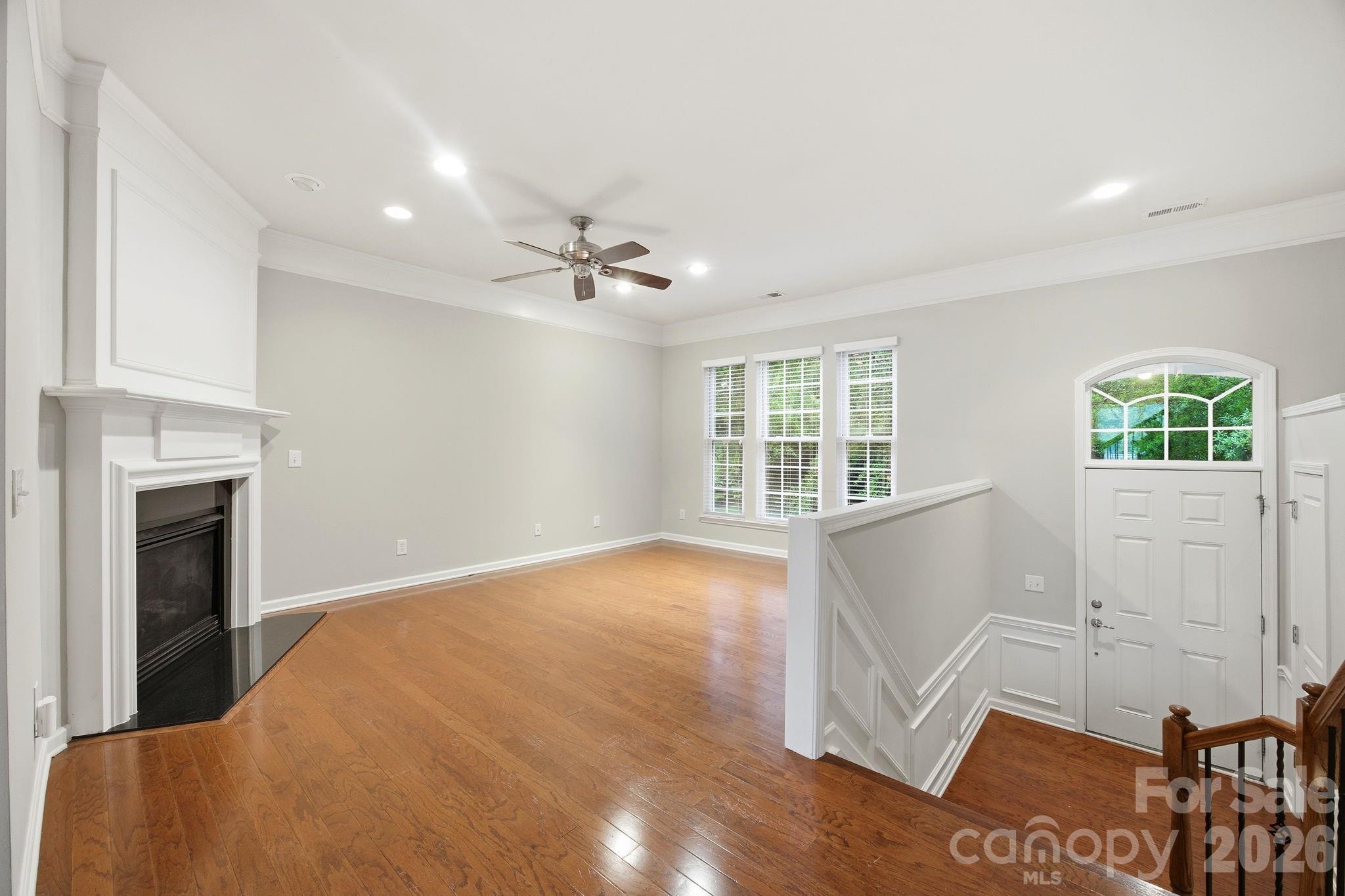 645 6th Baxter Crossing Fort Mill, SC 29708 - Photo 3 of 32 a view of an empty room with a window and wooden floor