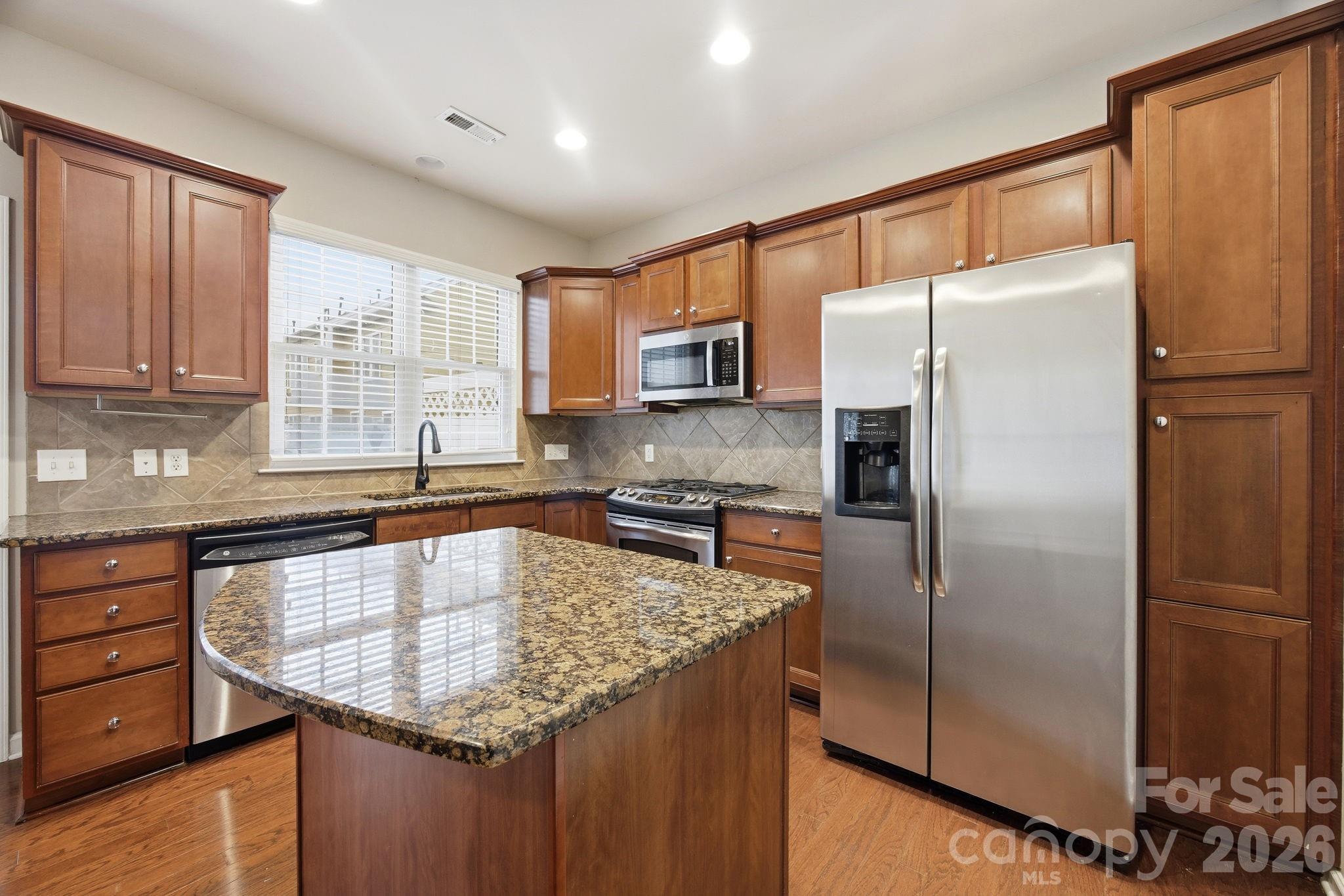 645 6th Baxter Crossing Fort Mill, SC 29708 - Photo 4 of 32 a kitchen with stainless steel appliances granite countertop a refrigerator a sink and a stove
