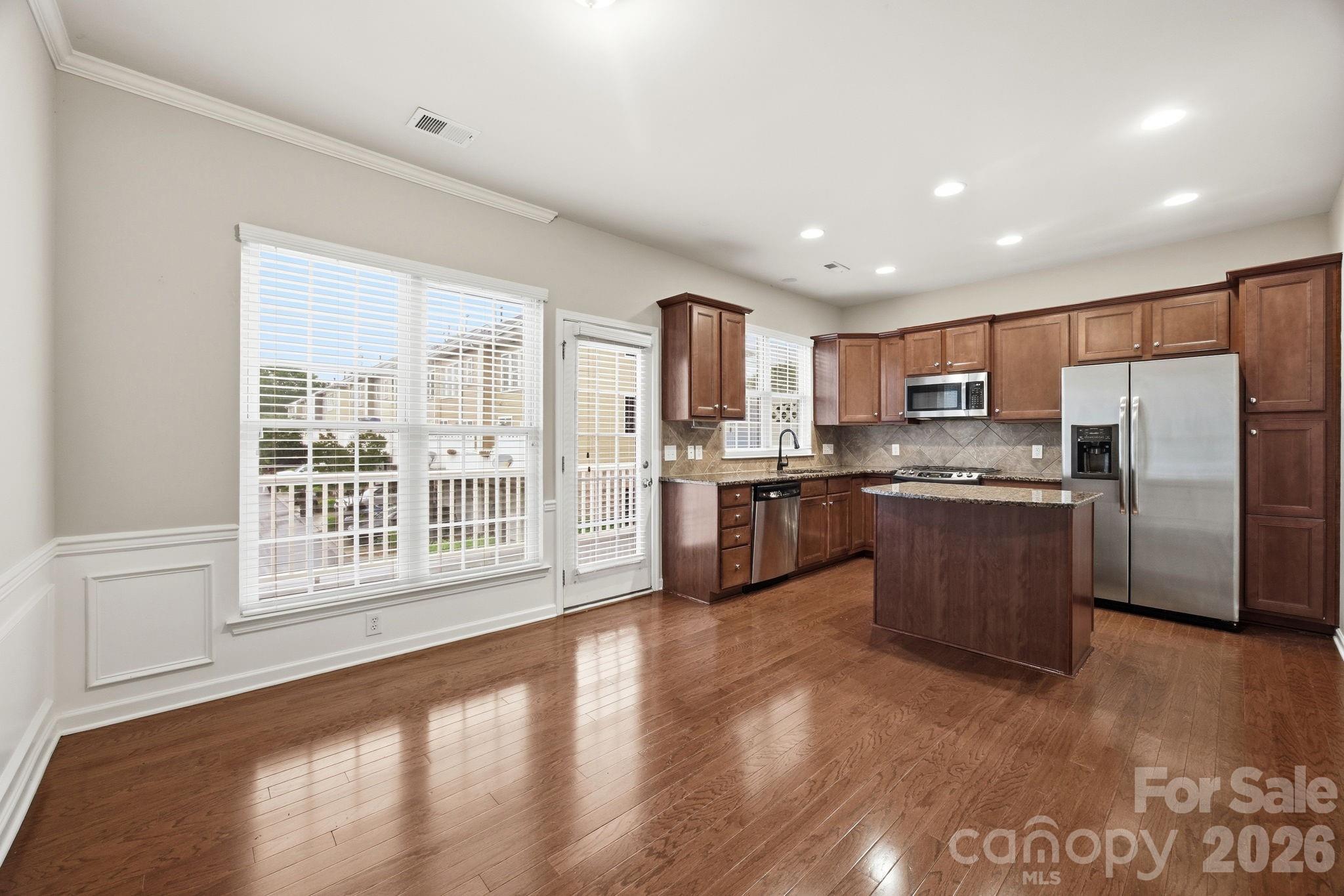 645 6th Baxter Crossing Fort Mill, SC 29708 - Photo 6 of 32 a kitchen with stainless steel appliances a refrigerator a sink a stove top oven and cabinets