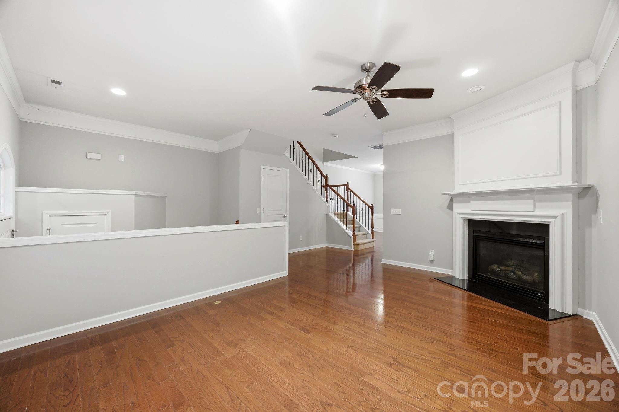 645 6th Baxter Crossing Fort Mill, SC 29708 - Photo 8 of 32 a view of an empty room with wooden floor a fireplace