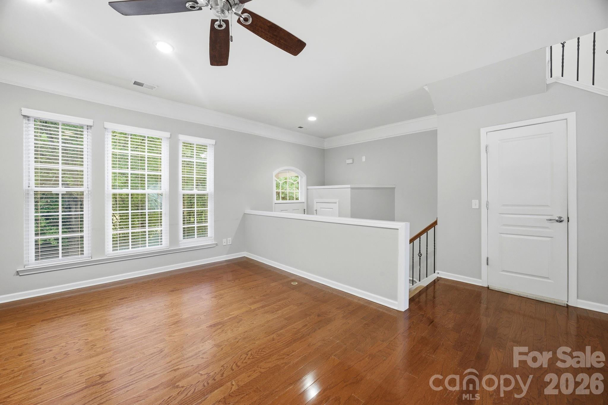 645 6th Baxter Crossing Fort Mill, SC 29708 - Photo 9 of 32 a view of empty room with wooden floor and fan