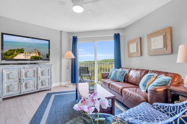 a living room with kitchen island granite countertop furniture and a fireplace