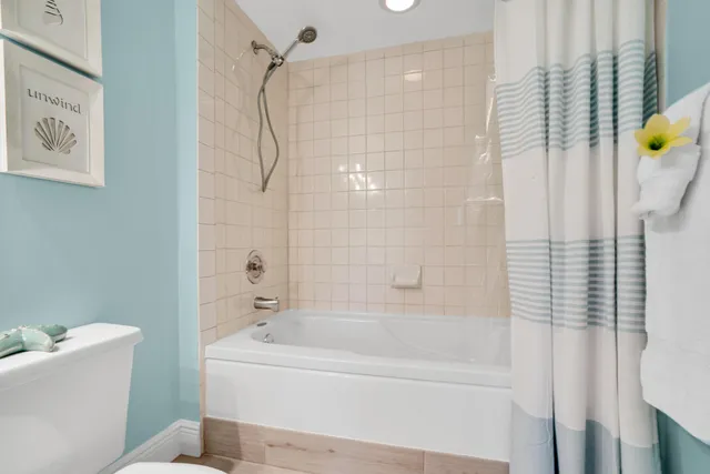 a bathroom with a granite countertop toilet a sink and a mirror