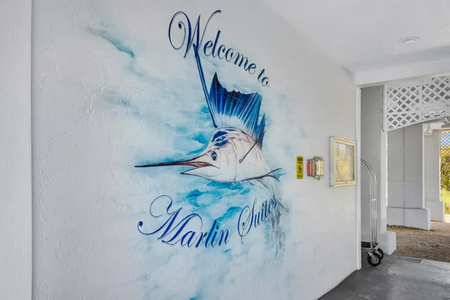 a view of a hallway with wooden floor closet and front door