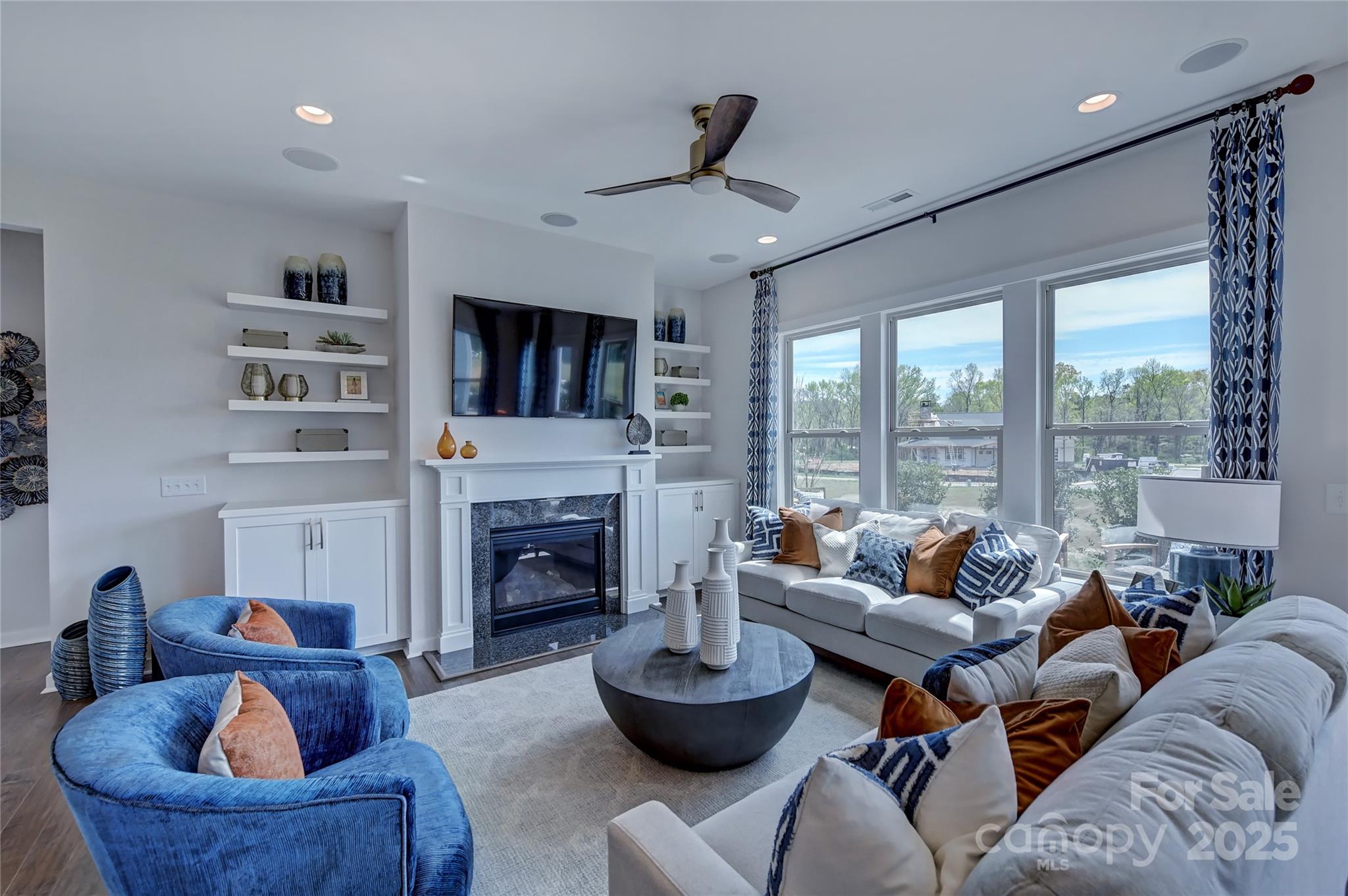 1475 Hubert Graham Way Tega Cay, SC 29708 - Photo 12 of 27 a living room with furniture a fireplace and a flat screen tv