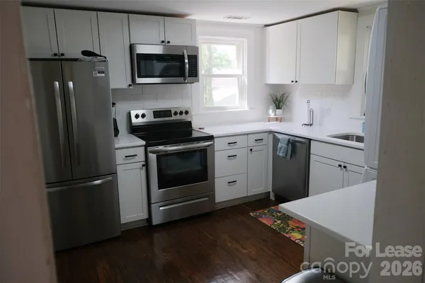 a kitchen with a sink stove and refrigerator