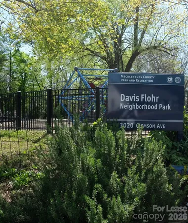 a view of outdoor space with sign board and tree
