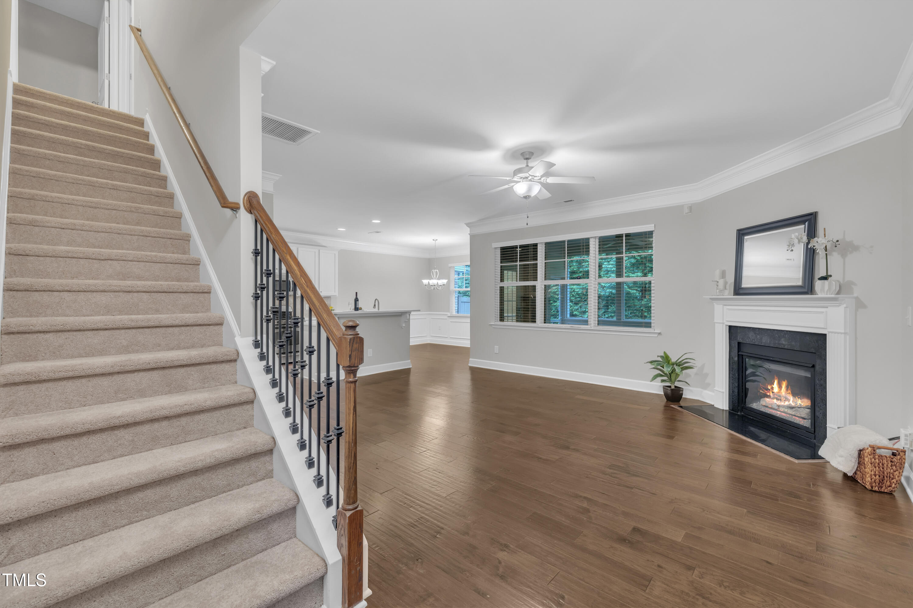 2073 Weston Green Loop Cary, NC 27513 - Photo 9 of 52 a view of an empty room with wooden floor fireplace and a window