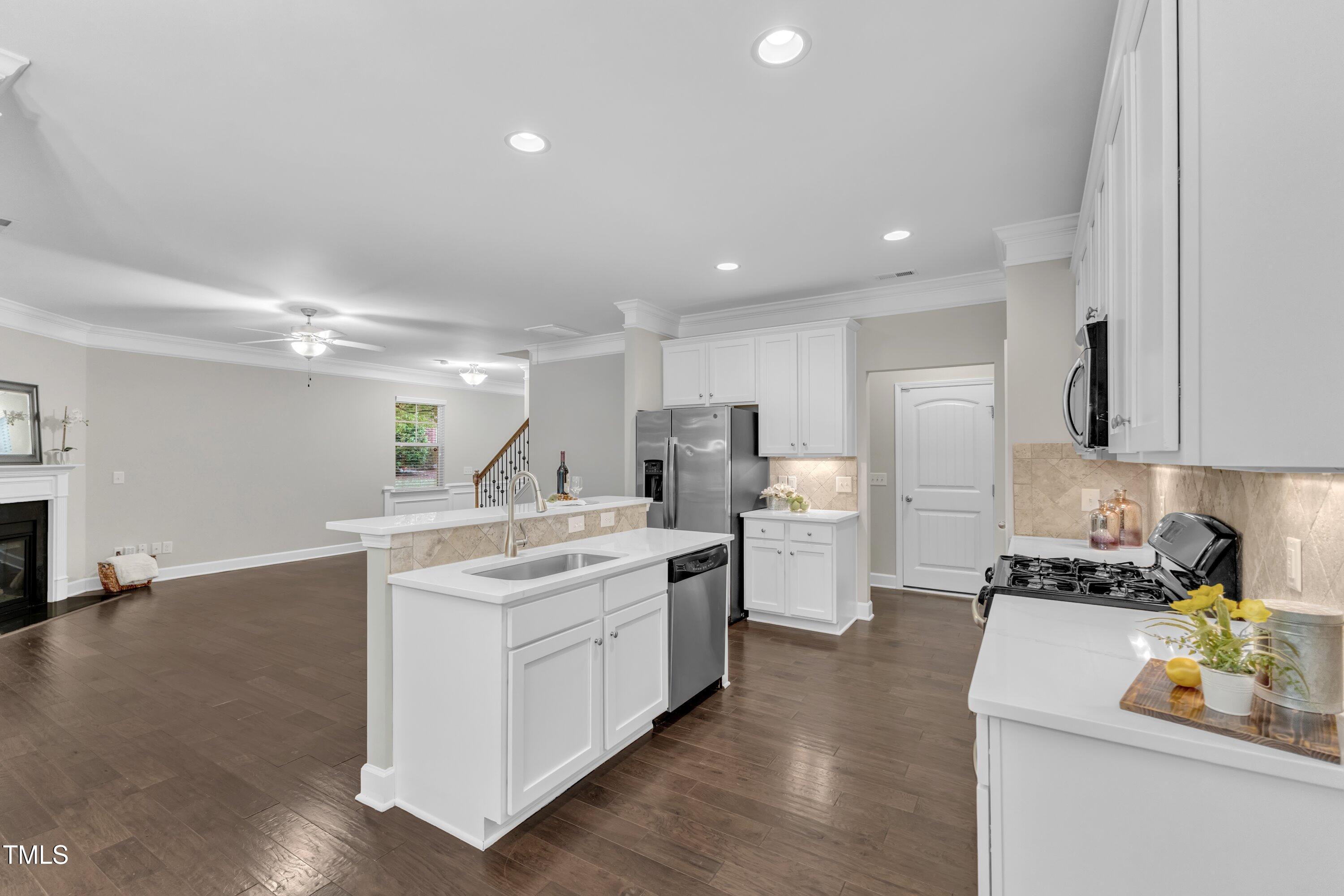 2073 Weston Green Loop Cary, NC 27513 - Photo 17 of 52 a kitchen with a sink stove and cabinets
