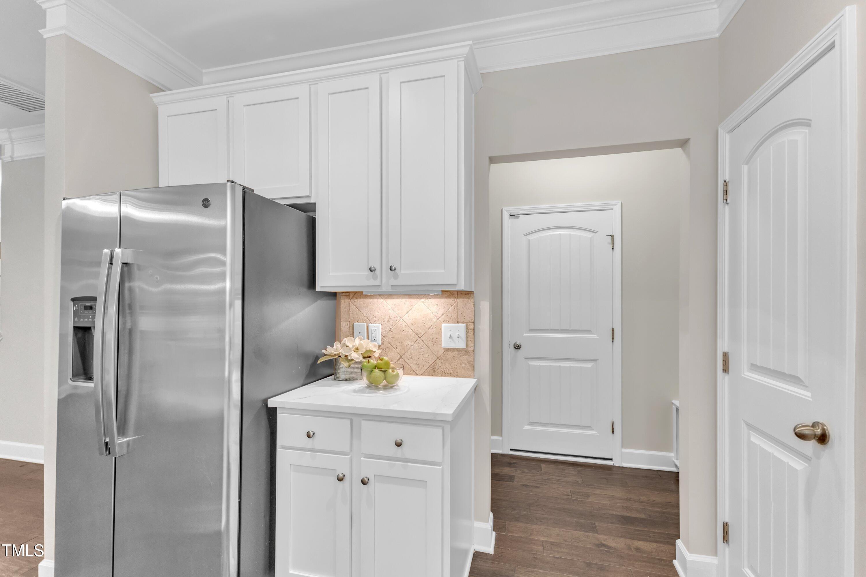 2073 Weston Green Loop Cary, NC 27513 - Photo 20 of 52 a kitchen with a refrigerator and cabinets