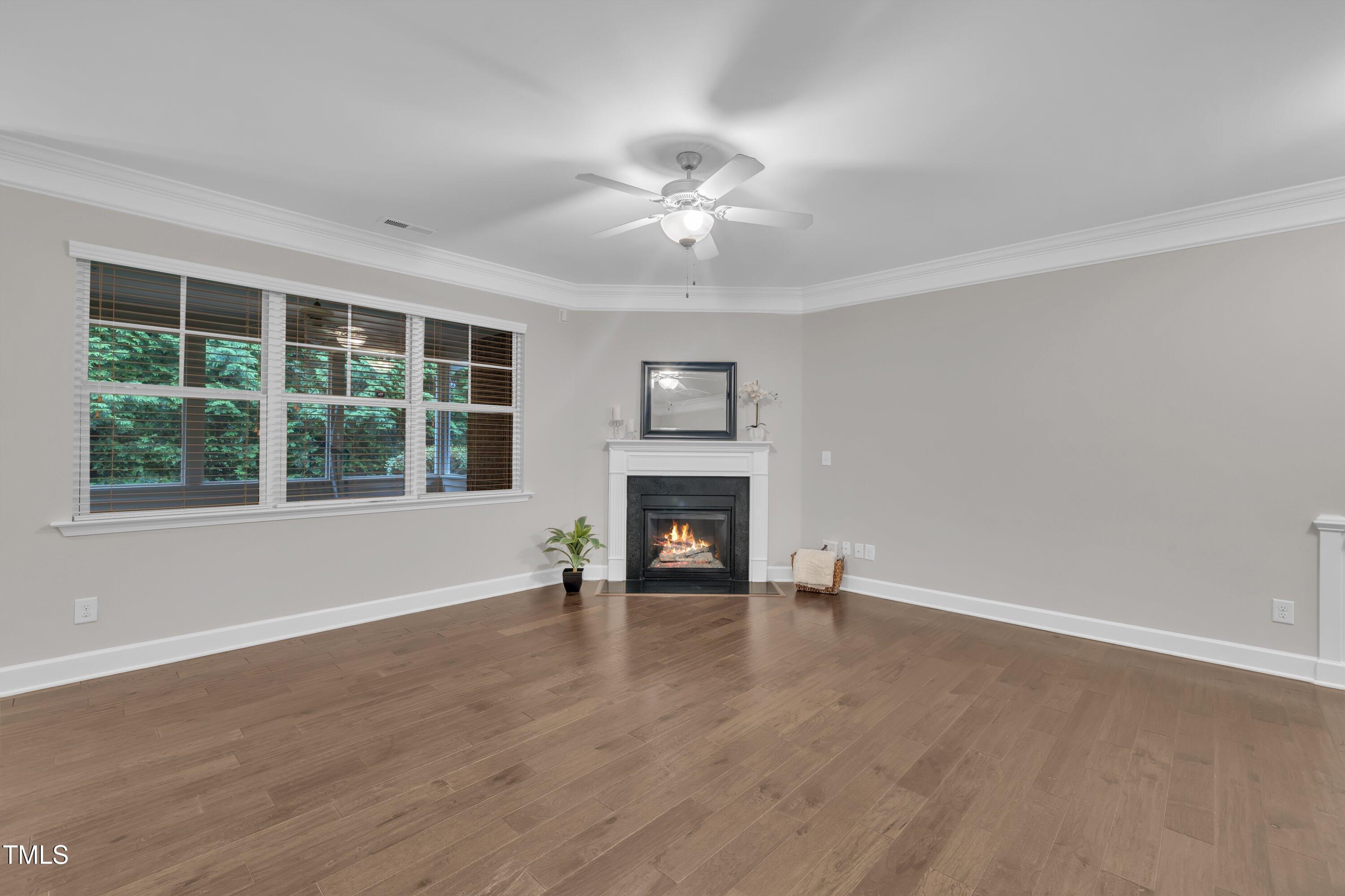 2073 Weston Green Loop Cary, NC 27513 - Photo 23 of 52 a view of an empty room with a window and fireplace