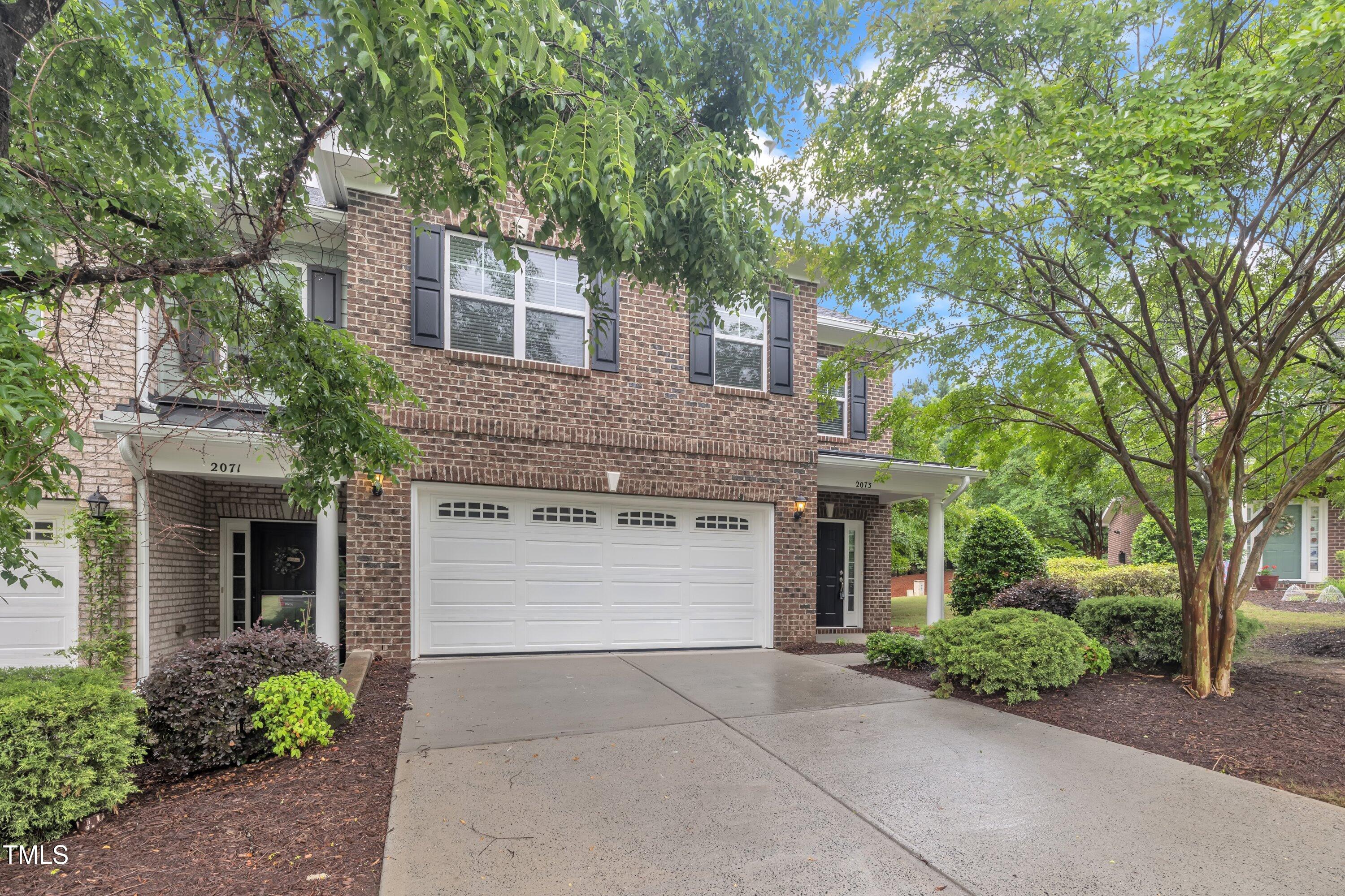 2073 Weston Green Loop Cary, NC 27513 - Photo 2 of 52 a front view of a house with yard and parking