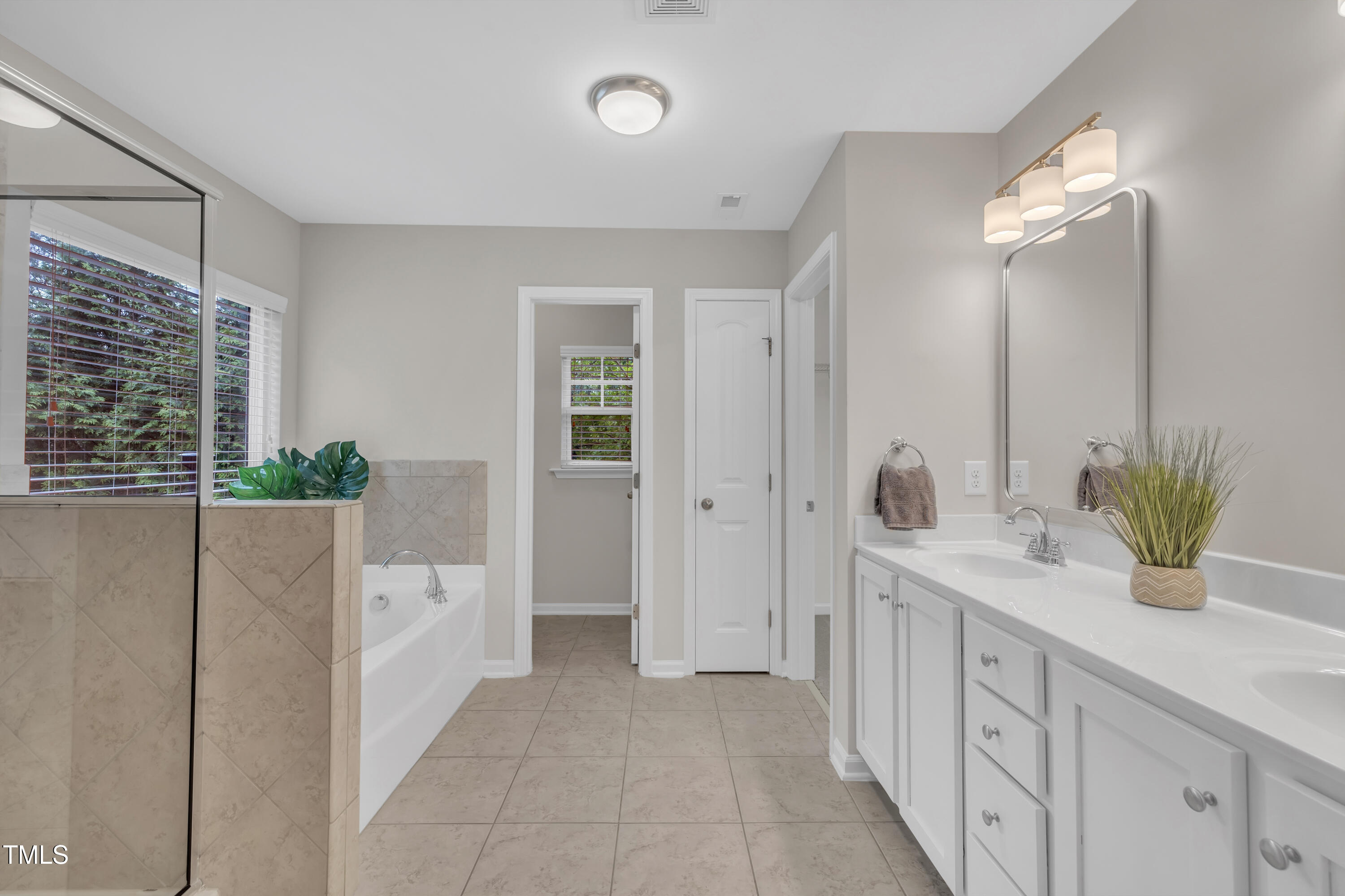 2073 Weston Green Loop Cary, NC 27513 - Photo 31 of 52 a bathroom with a double vanity sink and a mirror