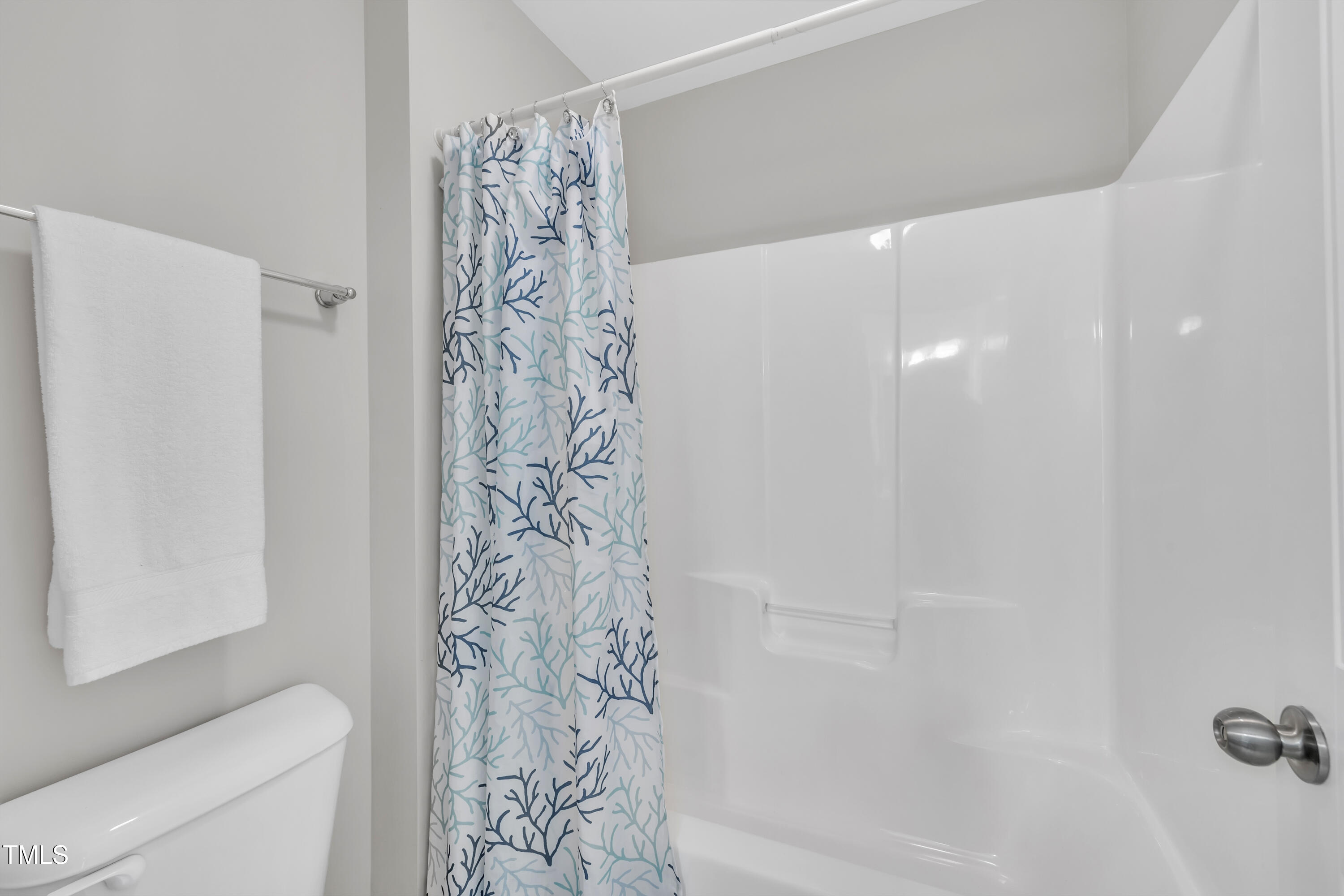 2073 Weston Green Loop Cary, NC 27513 - Photo 39 of 52 a bathroom with a shower curtain and a toilet