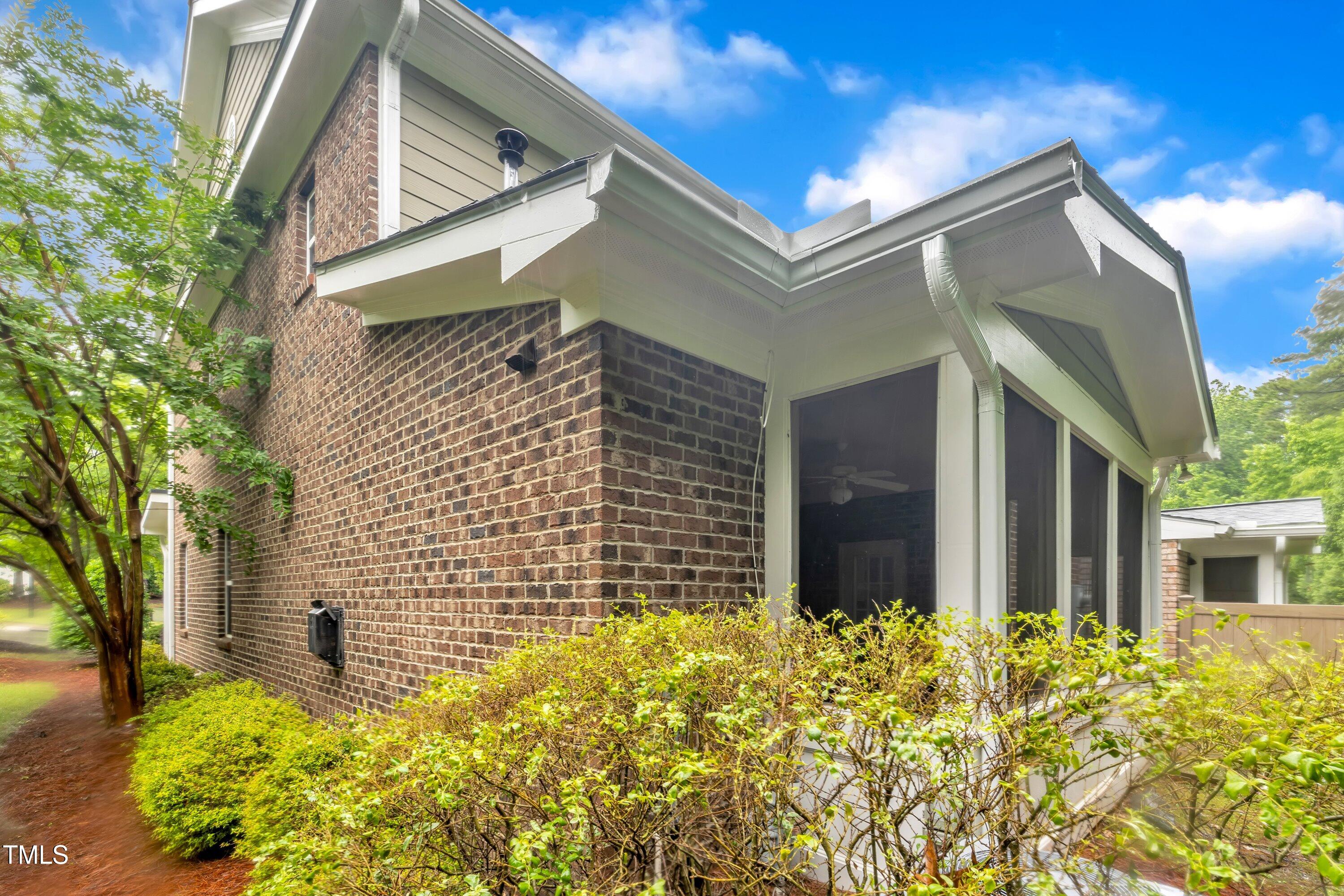 2073 Weston Green Loop Cary, NC 27513 - Photo 44 of 52 a view of brick house with a large tree