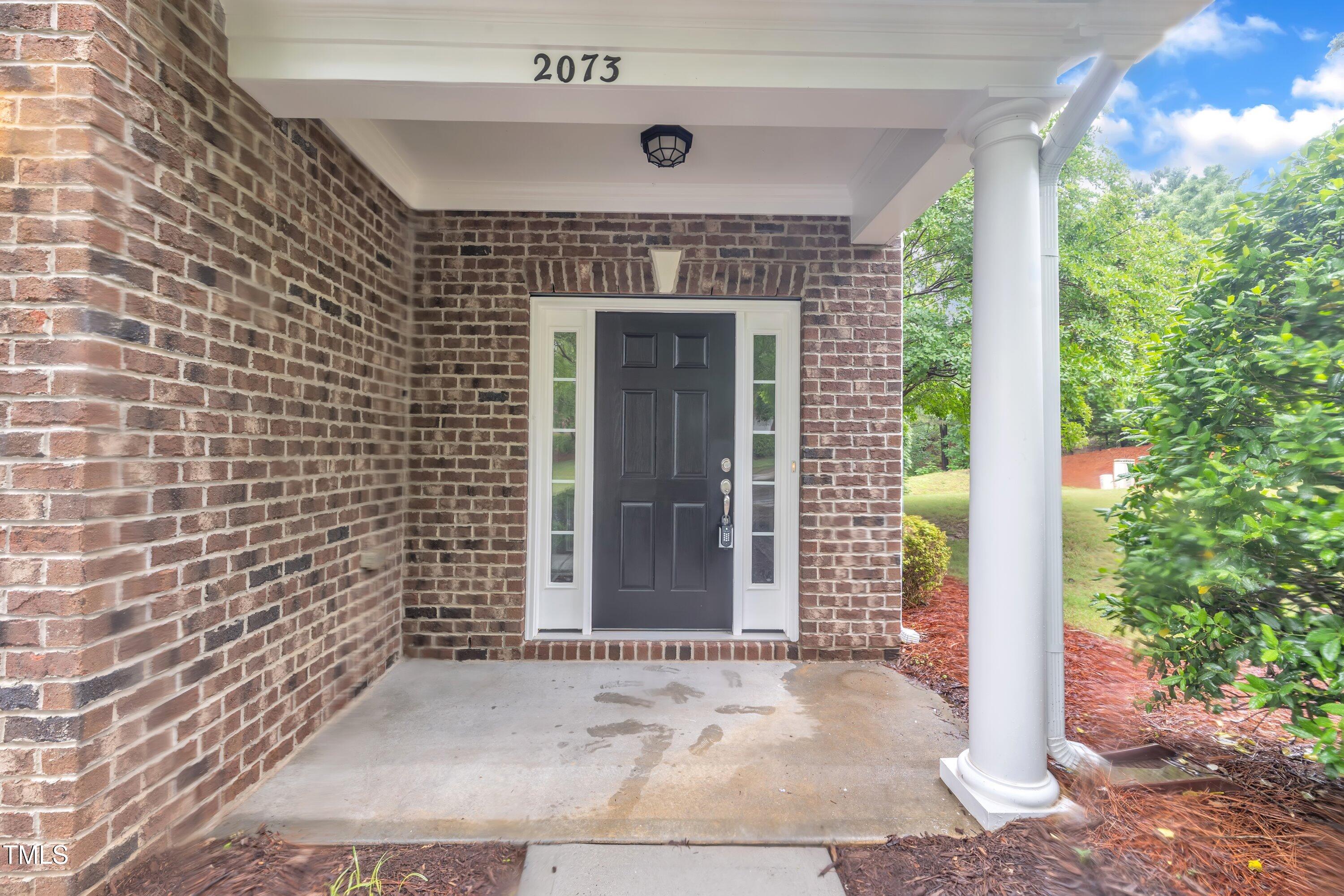 2073 Weston Green Loop Cary, NC 27513 - Photo 5 of 52 a front view of a house with a garden