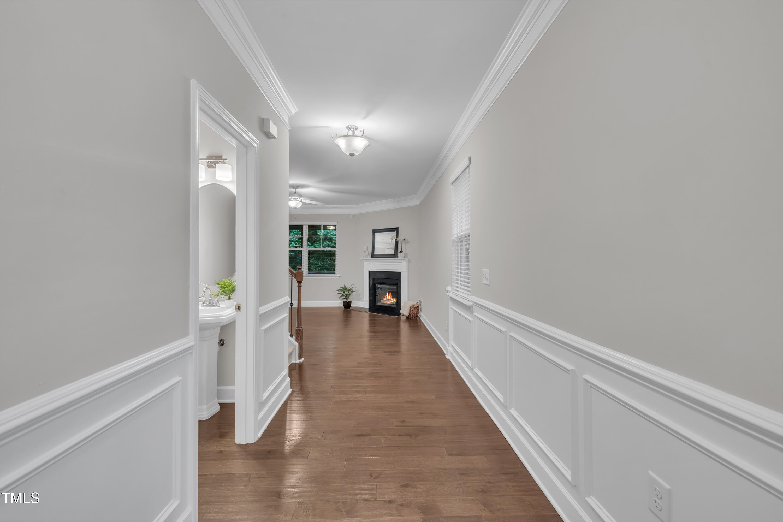 2073 Weston Green Loop Cary, NC 27513 - Photo 6 of 52 a hallway with wooden floor fireplace and windows