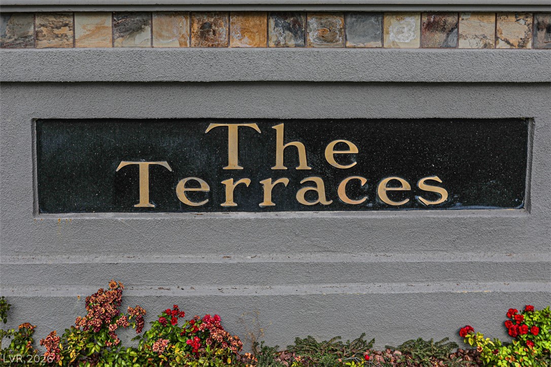 1134 Evening Ridge Street Henderson, NV 89052 - Photo 30 of 35 A refined entrance sign featuring stone and stucco, complemented by vibrant plantings.