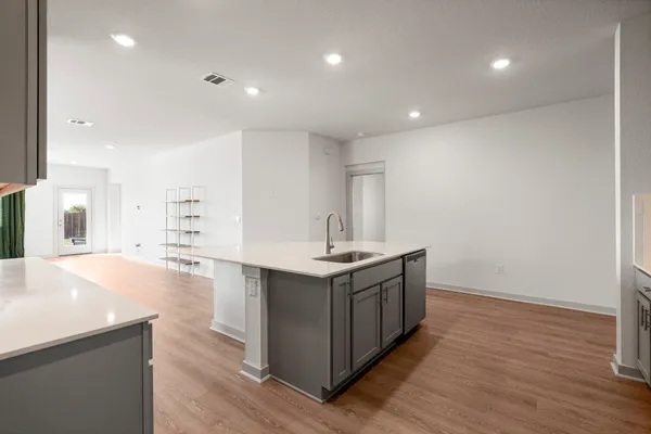 a kitchen that has a sink and a stove in it