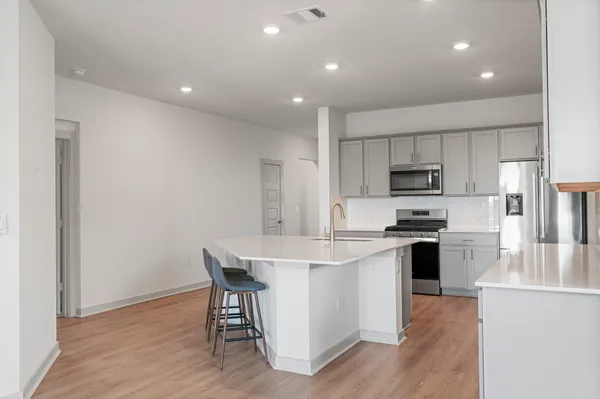 an empty room with cabinet and windows