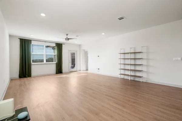 wooden floor in an empty room with a window