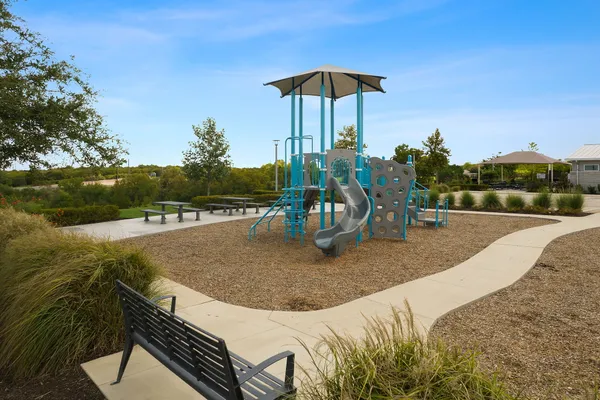an outdoor sitting area with furniture and umbrella