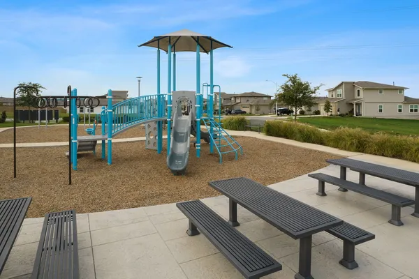 a view of a patio with couches table and chairs under an umbrella