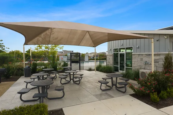 a swimming pool with outdoor seating and yard