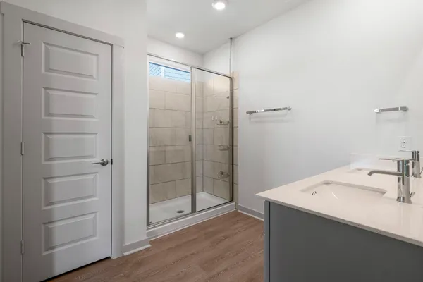 a bathroom with a shower sink and mirror