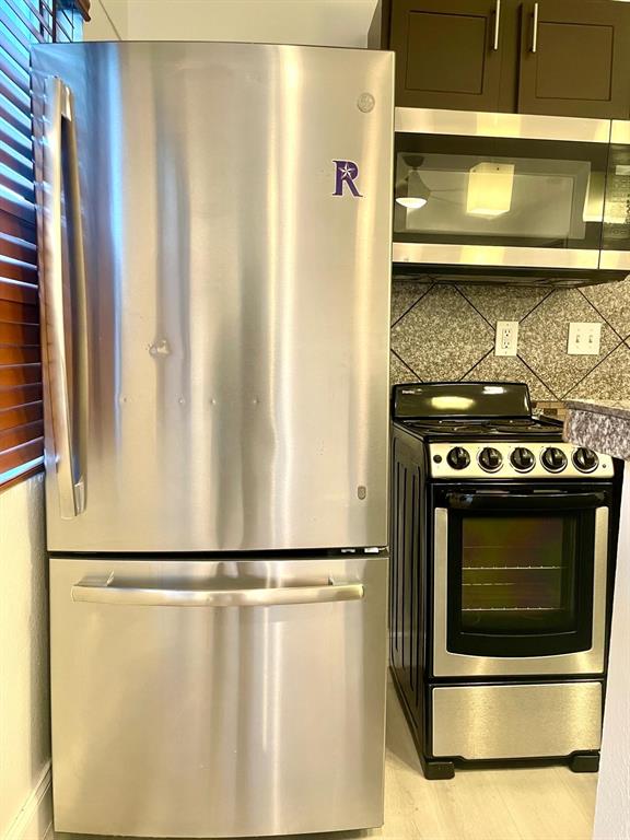 307 East Mitchell Street, Unit F Arlington, TX 76010 - Photo 11 of 15 a stove top oven sitting inside of a kitchen