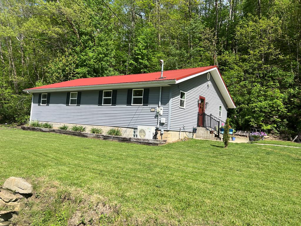 155 Cherry Run Road Rouseville, PA 16344 - Photo 1 of 19 a backyard of a house with table and chairs
