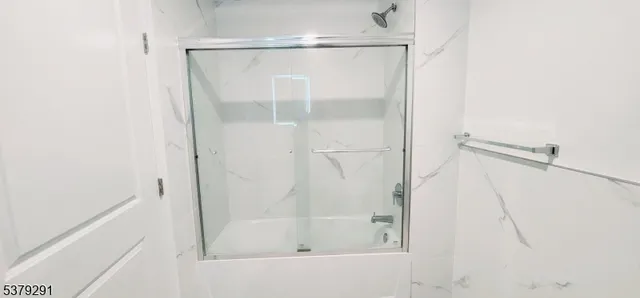 a bathroom with a glass shower door