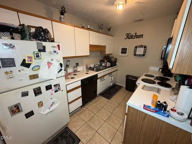 a kitchen with a white cabinets and white appliances