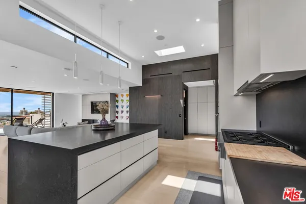a kitchen with counter top space sink and refrigerator