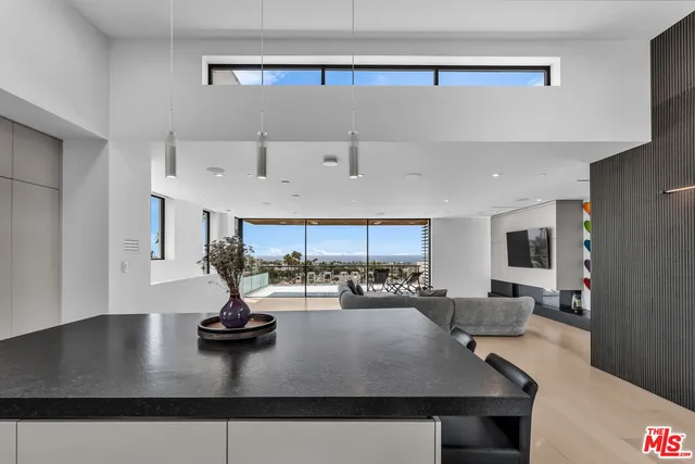 a view of a living room and kitchen
