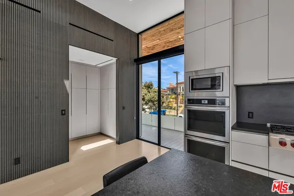 a kitchen with stainless steel appliances a stove a microwave and a sink