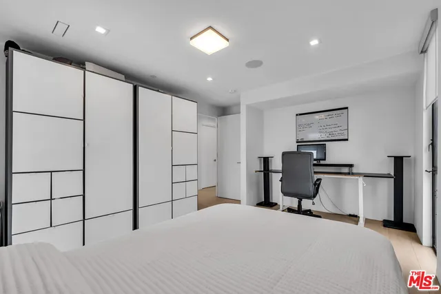 a bedroom with a bed a desk and chair