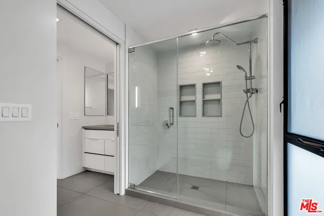 a bathroom with a glass shower door