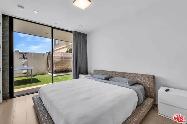 a bedroom with a bed and a large window