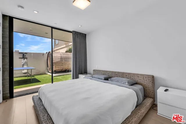 a bedroom with a bed and a large window