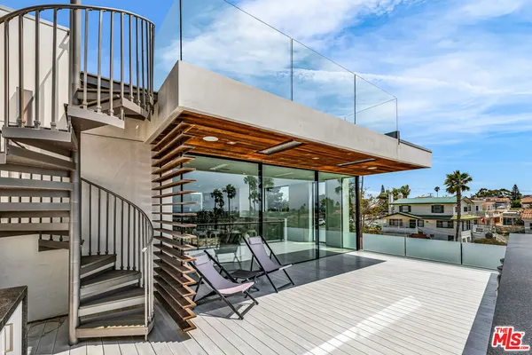a patio with a table and chairs